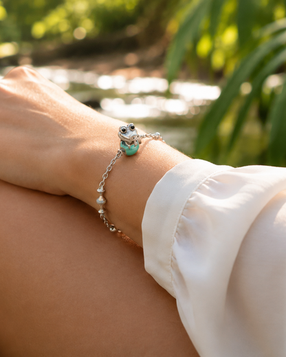 Baby crocodile charm in polished 950 sterling silver with glossy black enamel eyes, on a glossy Tiffany-blue enamel egg bead — handcrafted jewelry by Priscilla Sayegh