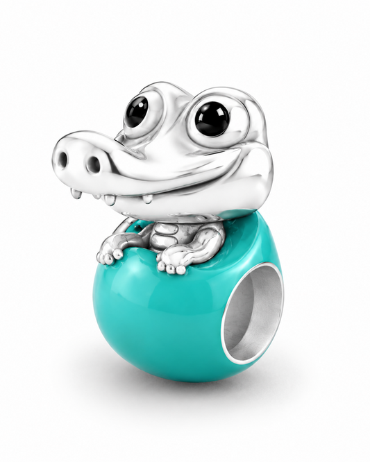 Baby crocodile charm in polished 950 sterling silver with glossy black enamel eyes, on a glossy Tiffany-blue enamel egg bead — handcrafted jewelry by Priscilla Sayegh